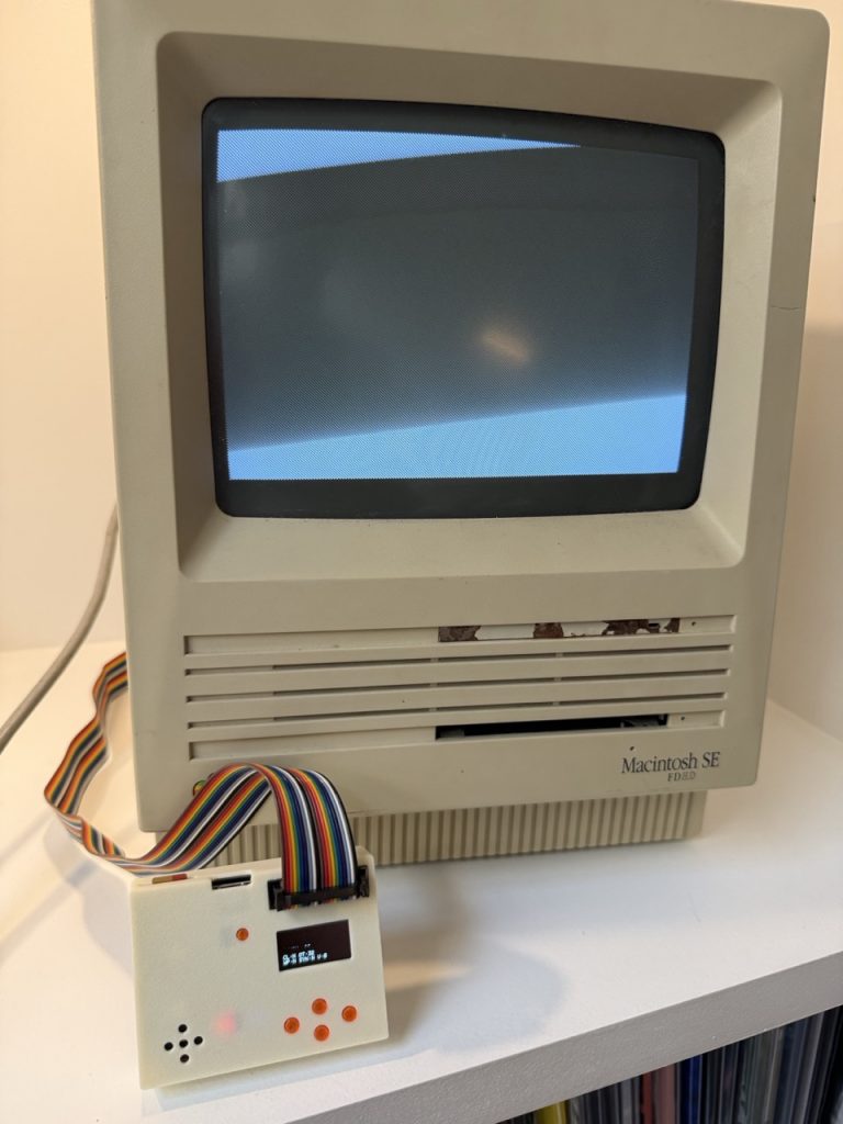 A Macintosh SE with the SmartDisk II plugged into its external floppy port